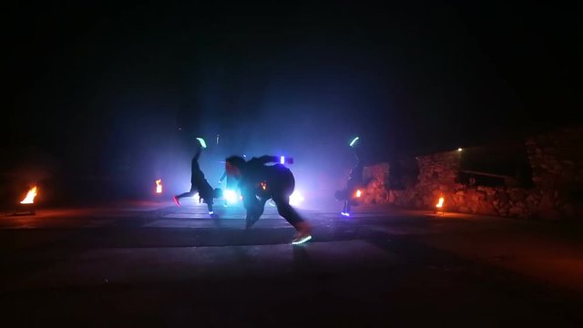 Street dancing. Five dancers dance in the night with shoes in shades that glow in different colors at night. Part 11