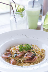 Spicy spaghetti and homemade sausage with thai style cooking, fusion food between italian food and thai ingredient and cooking style.