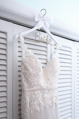 Wedding Dress hanging on Hanger with the word Bride