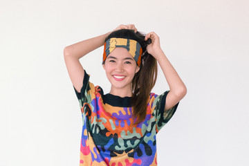 Fashion Portrait of Young cute asian woman wearing  80’s vintage colourful cloth and headband