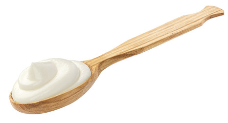 Sour cream in wooden spoon isolated on white background