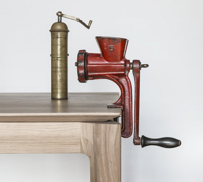 Image of antique meat grinding machine and brass coffee grinder