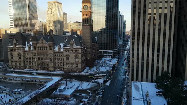 Toronto, Canada skyline downtown day view at Nathan Philips Square.
Panoramic view of Toronto Old City Hall and surrounding buildings seen from Queen St W, on a cold day with snow.