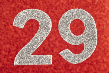 Number twenty-nine silver color over a red background. Anniversary