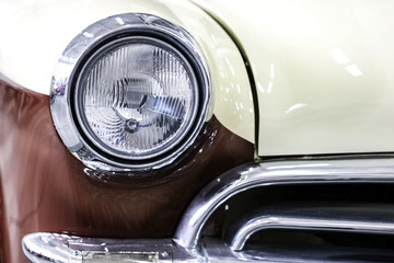 Color detail on the headlight of a vintage car.