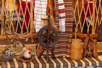 Old wooden spinning wheel, Russian folk art. Wooden spinning wheel decor for a restaurant in retro...