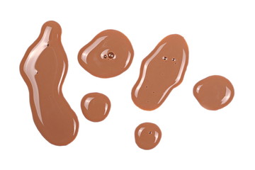 Spilled chocolate milk puddle isolated on white background, top view