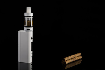 electronic cigarette and a piece of cinnamon on a black background