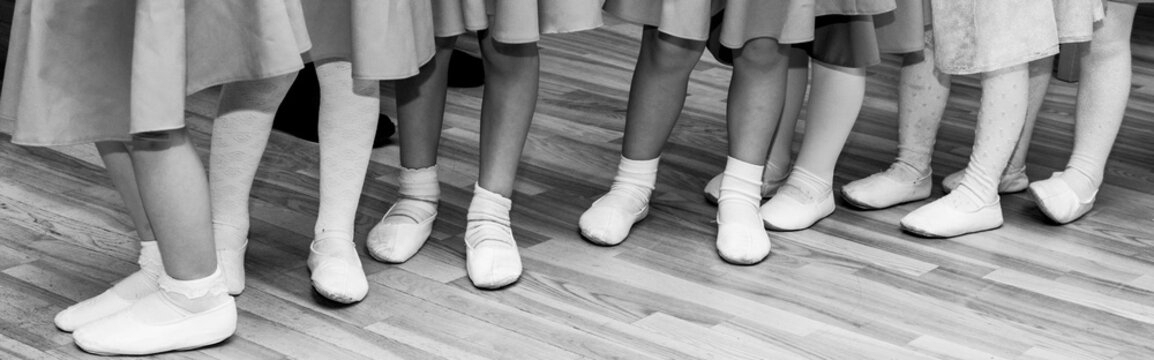 Children's Legs In Ballet Slippers