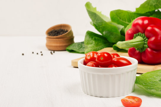 Healthy Raw Vegetables - Cherry Tomatoes, Paprika, Greens Salad And Pepper On Soft White Wood Background, Copy Space.