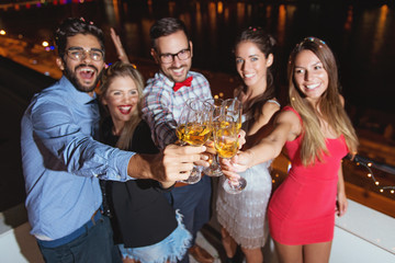 Group of people having a party on the roof, cheering with champagne  