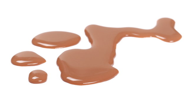 Spilled chocolate milk puddle isolated on white background