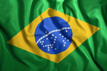 The Brazilian flag flies in the wind. Colorful national flag of Brazil. Patriotism, patriotic symbol.
