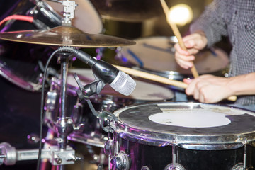 Fototapeta na wymiar Musician plays drums in a rock band