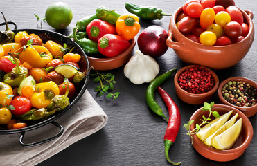 Rustic, oven baked vegetables with spices and herbs in baking dish