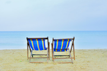 close up two casvas chair on beach with sunny day sea background in Thailand