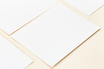 Blank white paper cards on a soft color background, business cards mockup