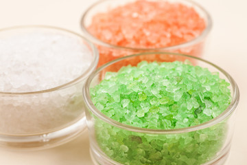 Red, green and white sea salt in glass bowls closeup