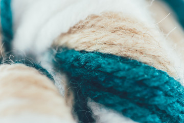 close up view of blue, beige and white knitting wool ball