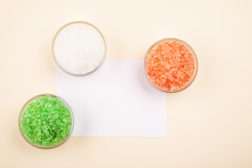 Red, green and white sea salt in glass bowls closeup, text space