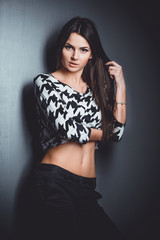 Beautiful, young and emotional girl in studio, on a dark background