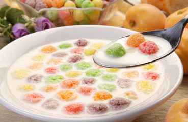 Spoon full of cereals balls and milk   