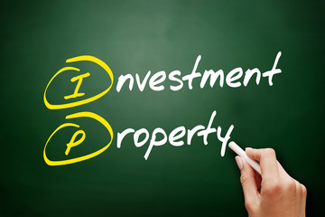 IP - Investment Property acronym, business concept on blackboard