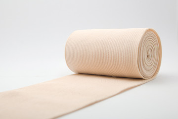 Medical gauze roll on white background.