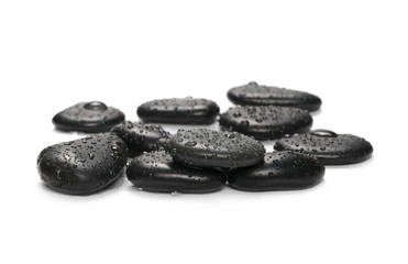 Black spa stones with water drops isolated on white background
