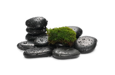 Green wet moss with black spa rocks and drops of water isolated on white background