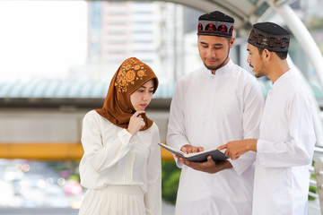 Muslim teen group reading book with shopping in the city,Concept education and shopping