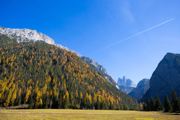 View of Tre Cime (Three Peaks) di Lavaredo on the background in autumn time, Dolomites., Italy.