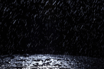 Dark background shot of rain falling - obrazy, fototapety, plakaty