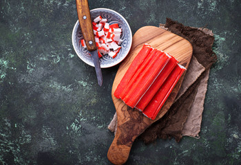 Crab sticks surimi and knife © Yulia Furman