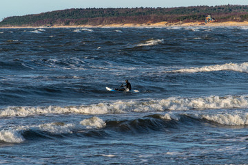 winter surfer in baltic sea 