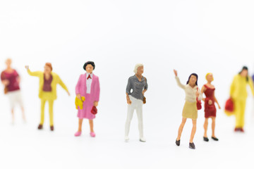 Miniature people: Group of women standing together, used to announce the International Working Women's Day. The definition is: Bread with roses for economic success.