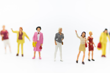 Obraz premium Miniature people: Group of women standing together, used to announce the International Working Women's Day. The definition is: Bread with roses for economic success.