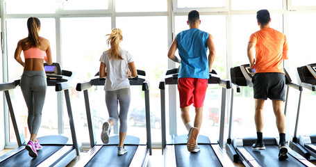 Fototapeta na wymiar Picture of people running on treadmill in gym