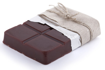 Handmade chocolate shaped soap with foil paper and rope isolated on white background