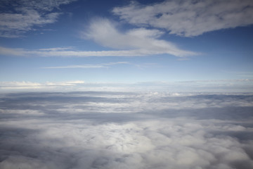 Fototapeta na wymiar flying high in a blue sky with white clouds and sun shine
