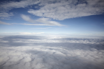 Fototapeta na wymiar flying high in a blue sky with white clouds and sun shine