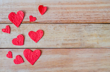 Red heart shape papers on wooden background