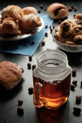 black tea in jar cup and biscuits