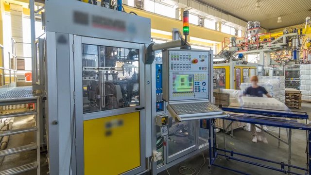 A factory for plastic canister production timelapse hyperlapse. The conveyor in the factory.
