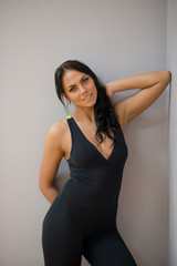 Fototapeta premium Woman Posing On Gym. Beautiful Athletic Girl With Fit Body In Black Sportswear, Doing Stretches Before Fitness Workout Outdoors. High Resolution