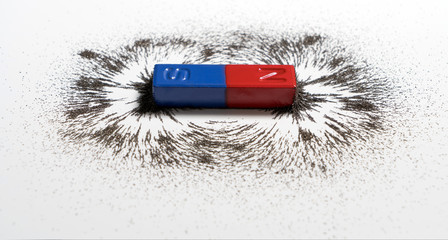 Red and blue bar magnet or physics magnetic with iron powder magnetic field on white background....
