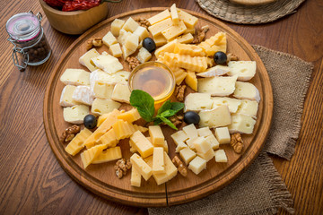 Assorted cheeses with honey and nuts