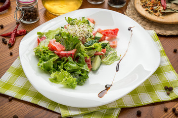 olive oil pouring into bowl of salad