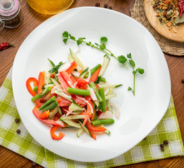 olive oil pouring into bowl of salad