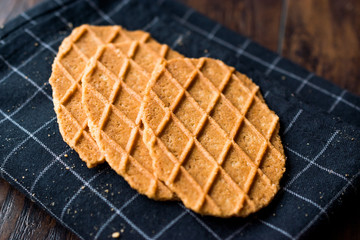 Fresh Crisp Waffles on Black Tablecloth.